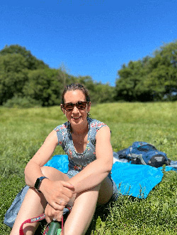 Abi Best Wellness Unwrapped (picture of a lady sat in a field in the sunshine)